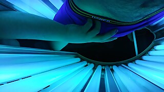 Woman strokes me while laying in a Tanning Bed